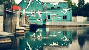 Il murale capovolto di Ray Bartkus: un’opera d’arte che si specchia sul Šešupė
