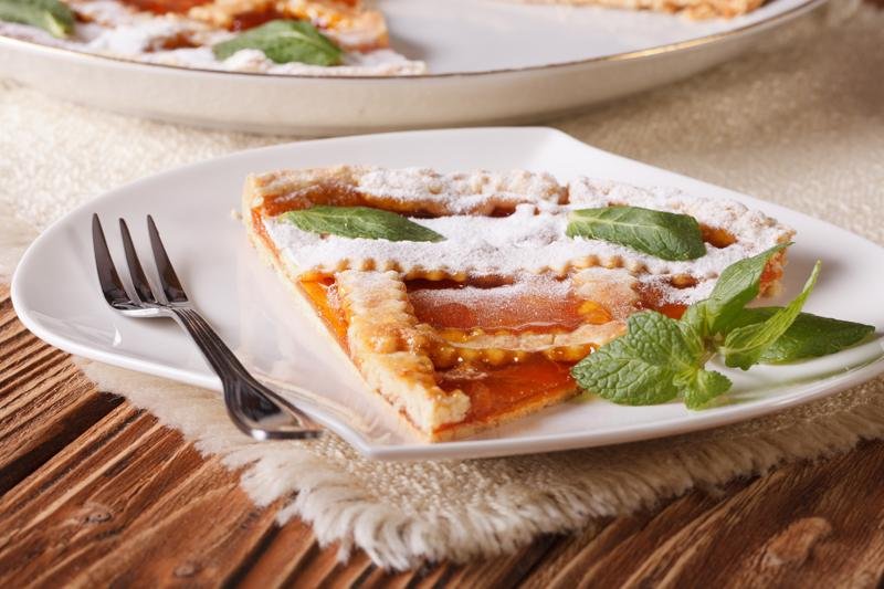 Slice of Italian tart with apricot close-up. Horizontal