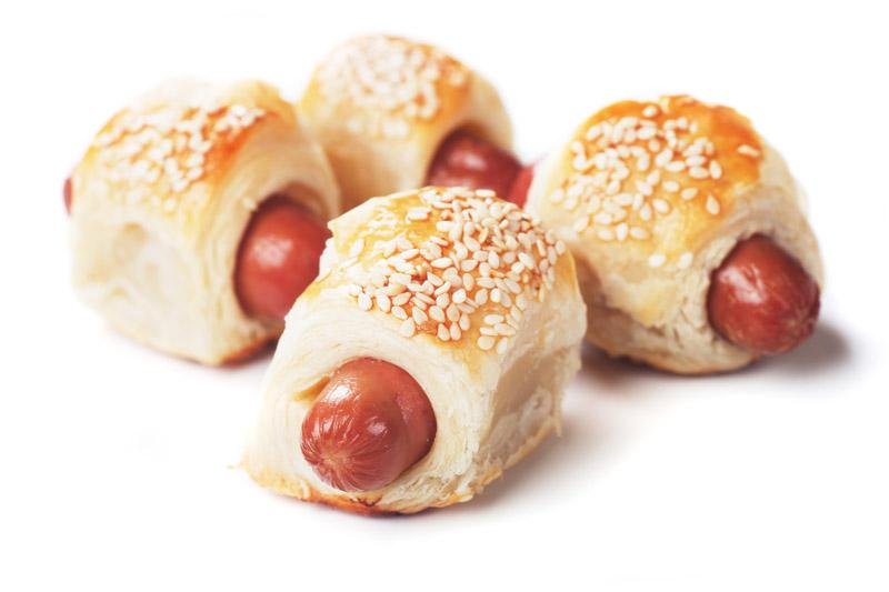 Pigs in blanket, sausage rolls with sesame covered puff pastry