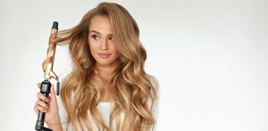 Curly Hair. Beautiful Woman Curling Long Wavy Hair With Iron
