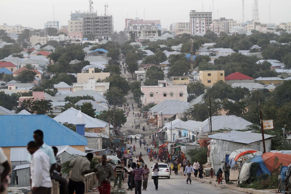 People walk along a street in Mogadishu